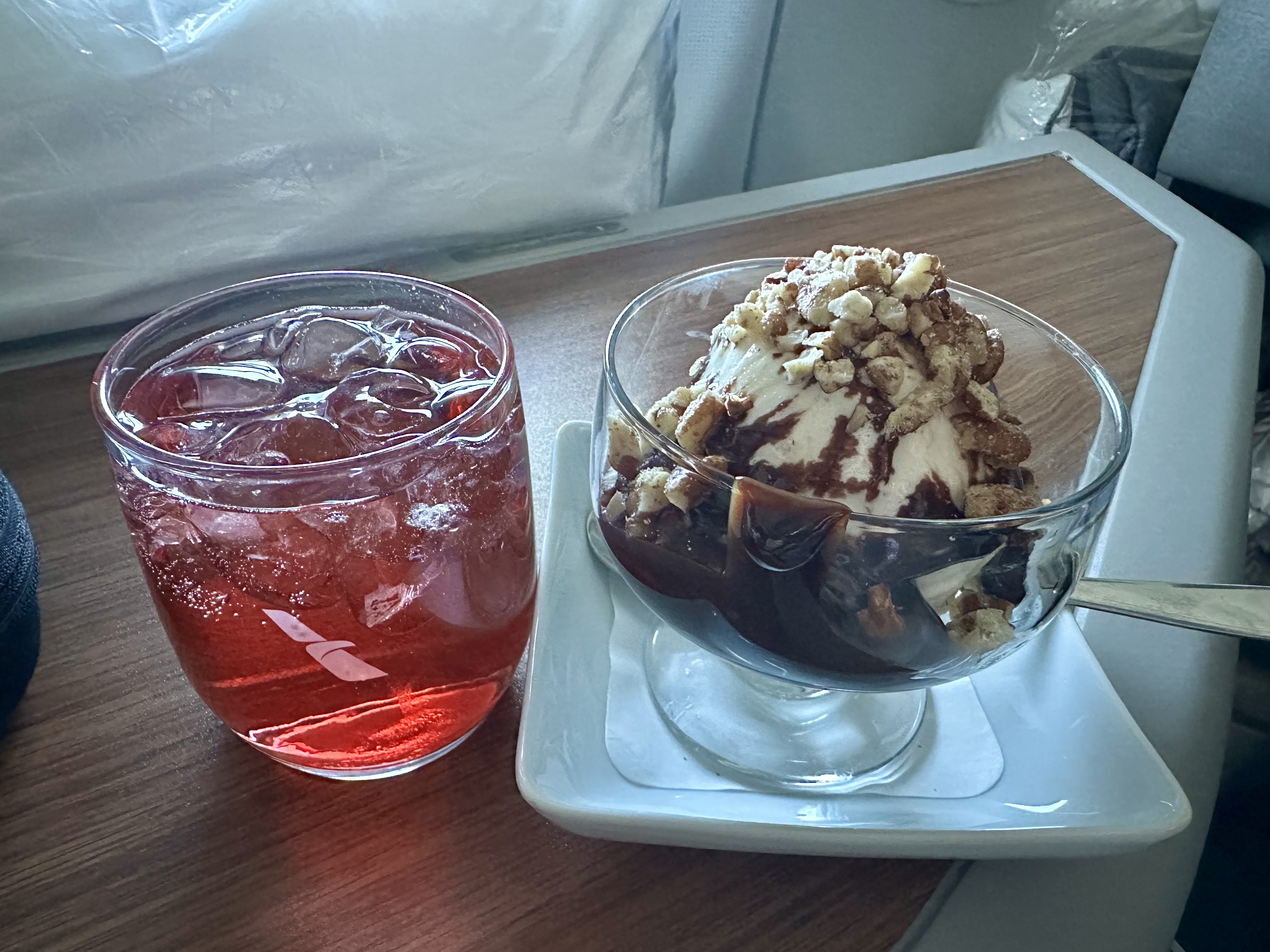 a bowl of ice cream and a drink on Flagship First From Orange County