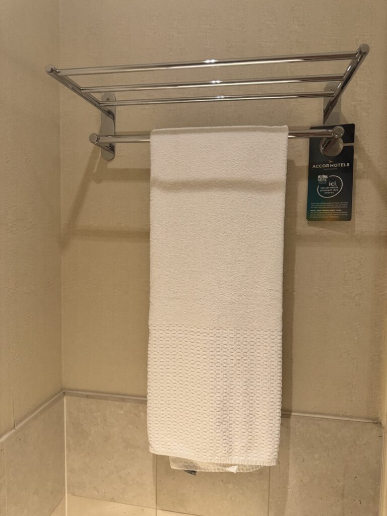 a white towel on a metal rack