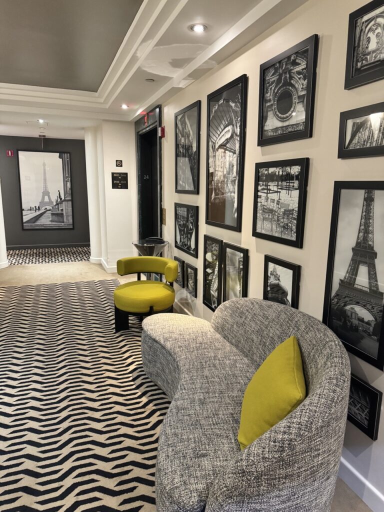 a room with a couch and pictures on the wall