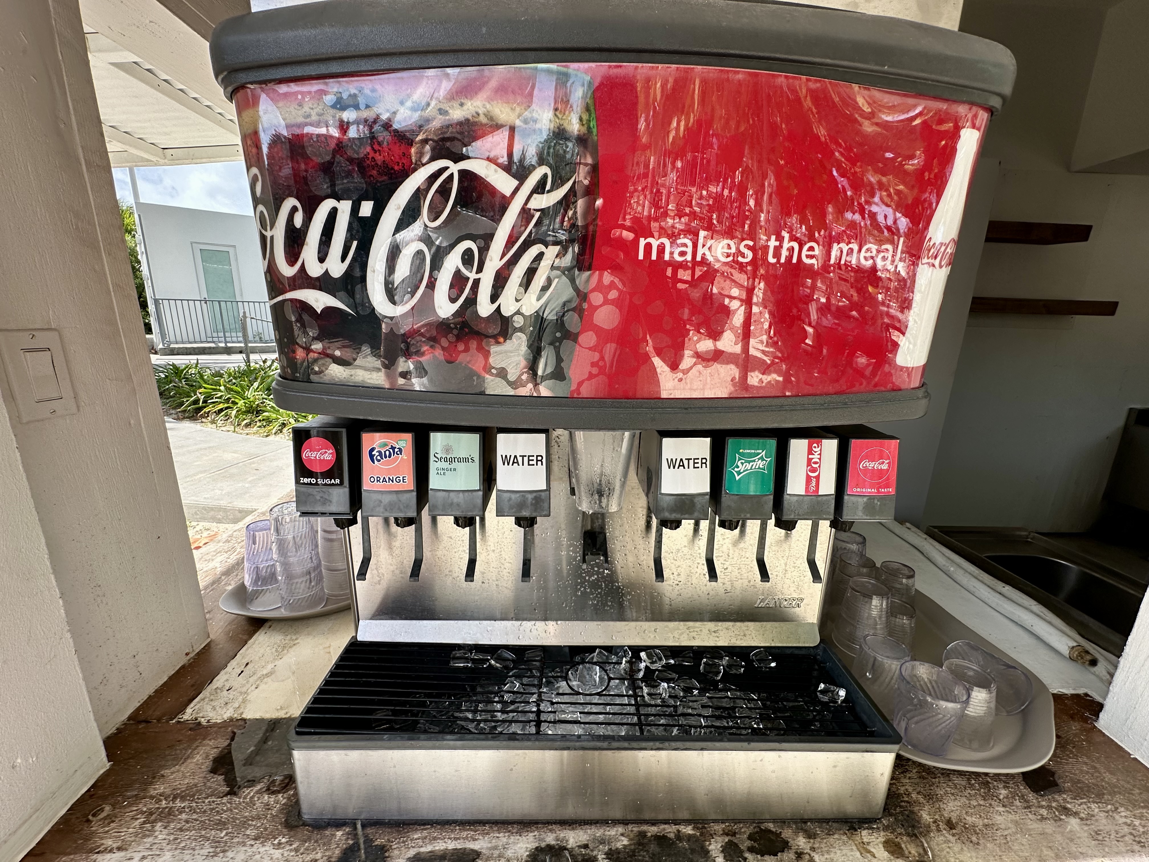 a soda dispenser with a red and white logo