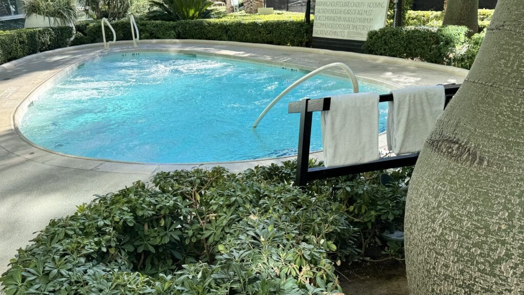 a pool with towels from a bar