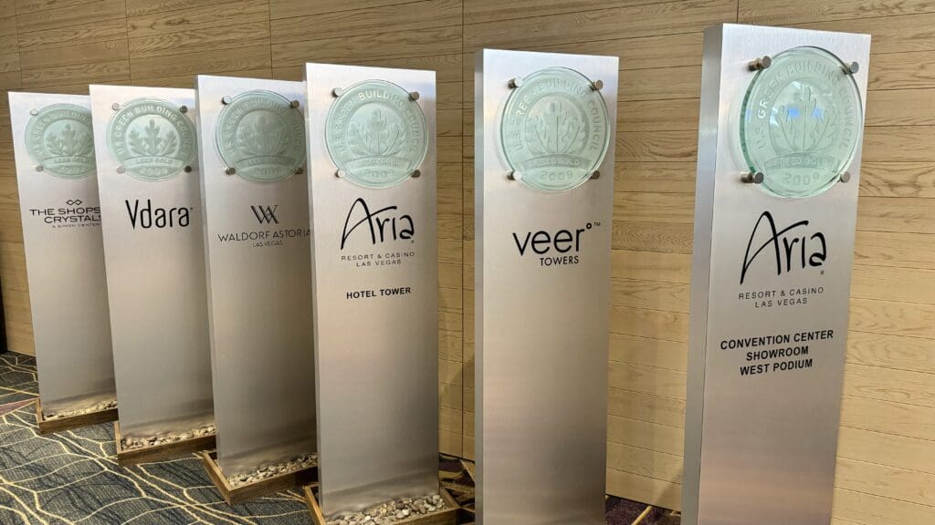 a group of metal pillars with logos on them