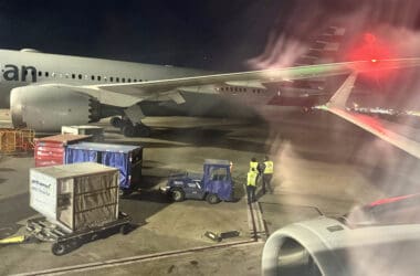 a plane with a few people standing next to it
