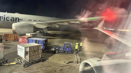 a plane with a few people standing next to it