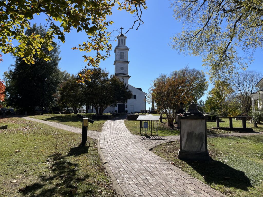 a brick path leading to a church