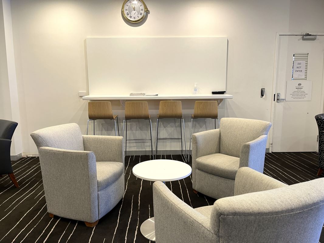 a room with chairs and a white board