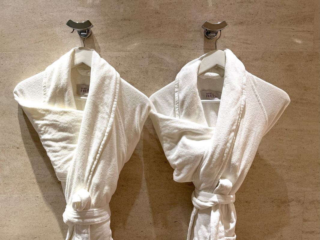 two white robes on a wall