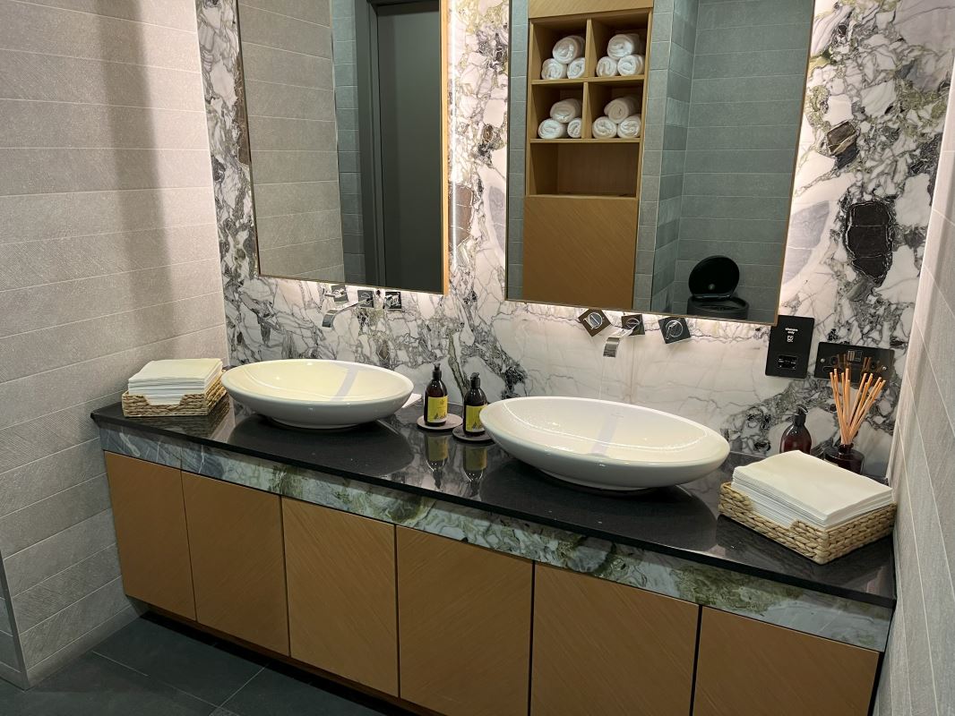 a bathroom with marble countertop sinks and mirrors