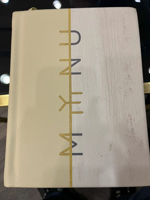 a white book with gold text on it