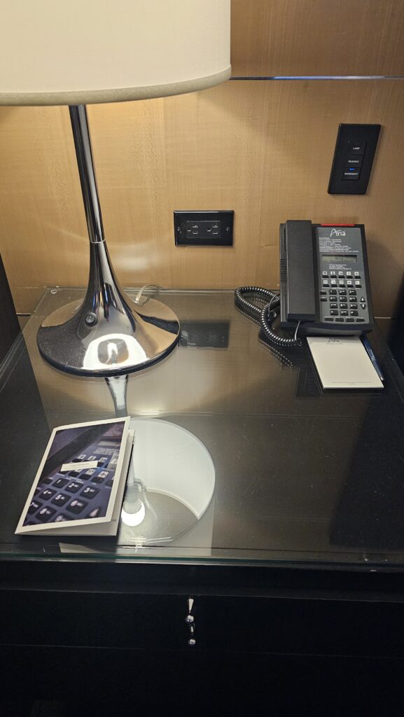 a phone and lamp on a glass table