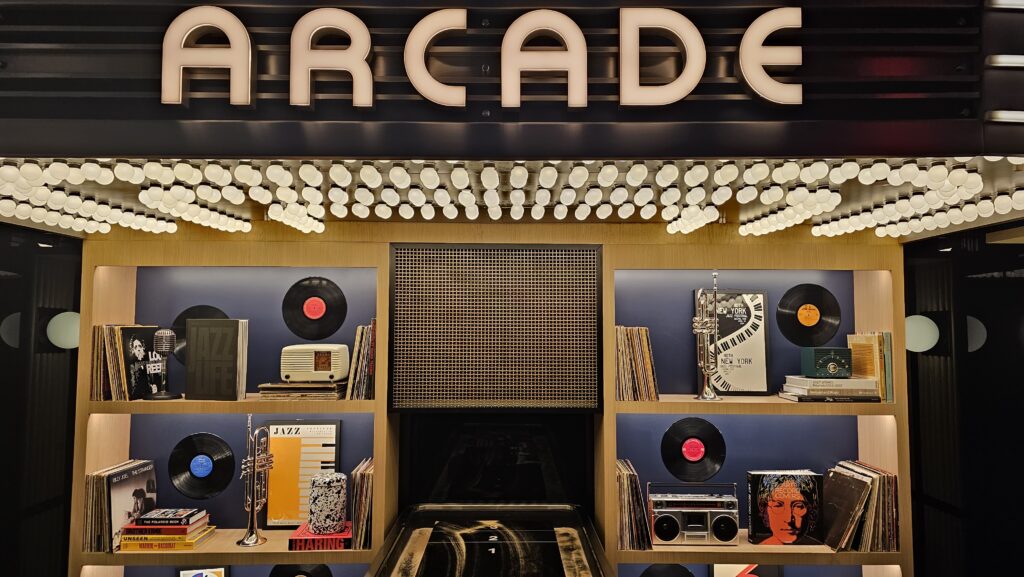 a store front with a sign and records on shelves