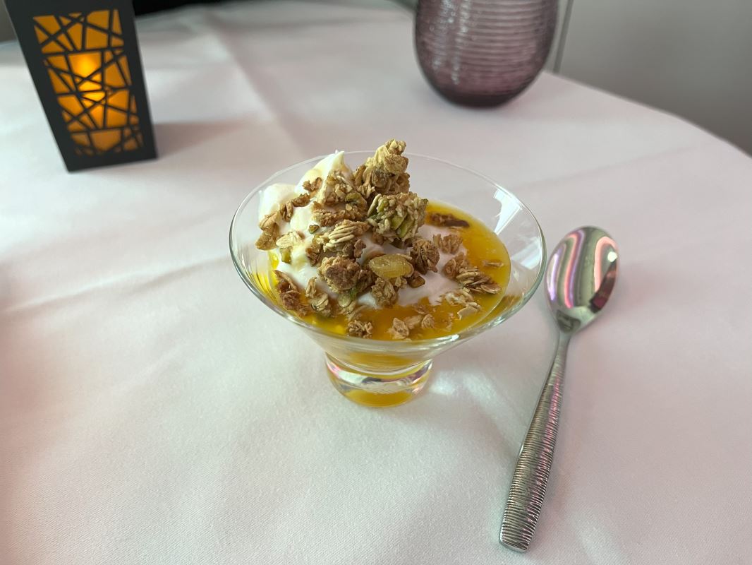 a dessert in a glass with a spoon