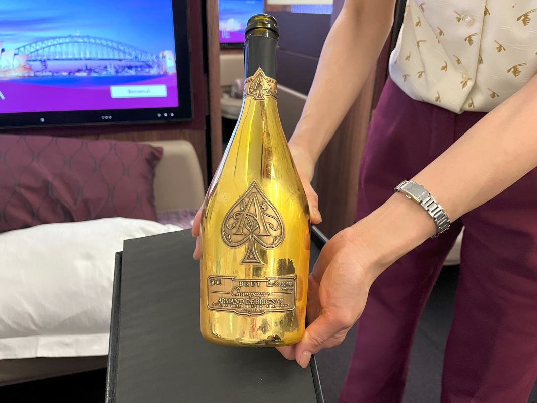 a person holding a gold bottle