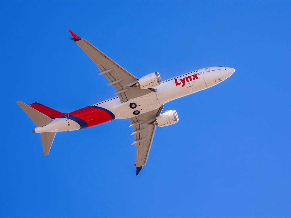 a white and red airplane in the sky