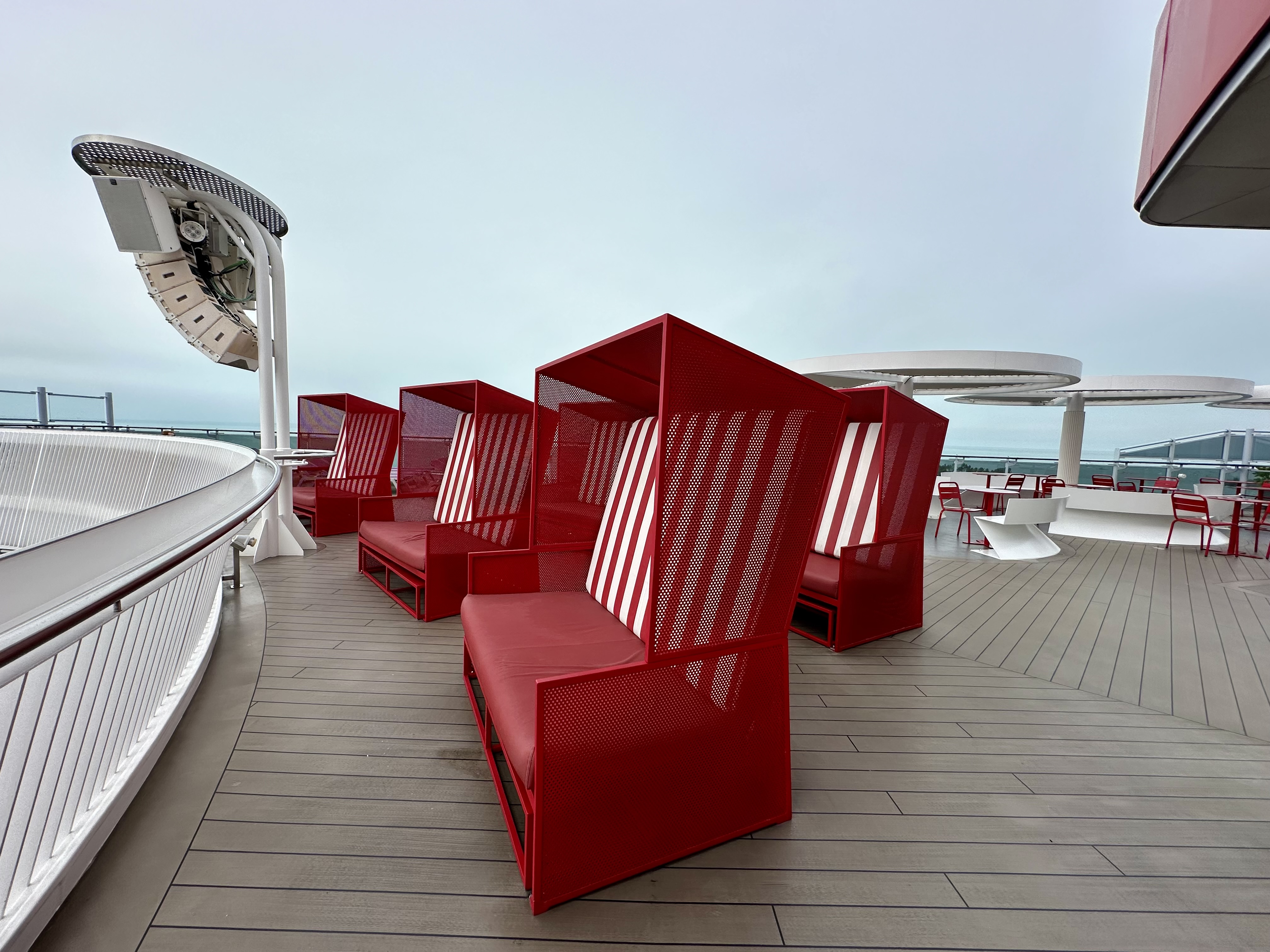 a group of red chairs on a deck