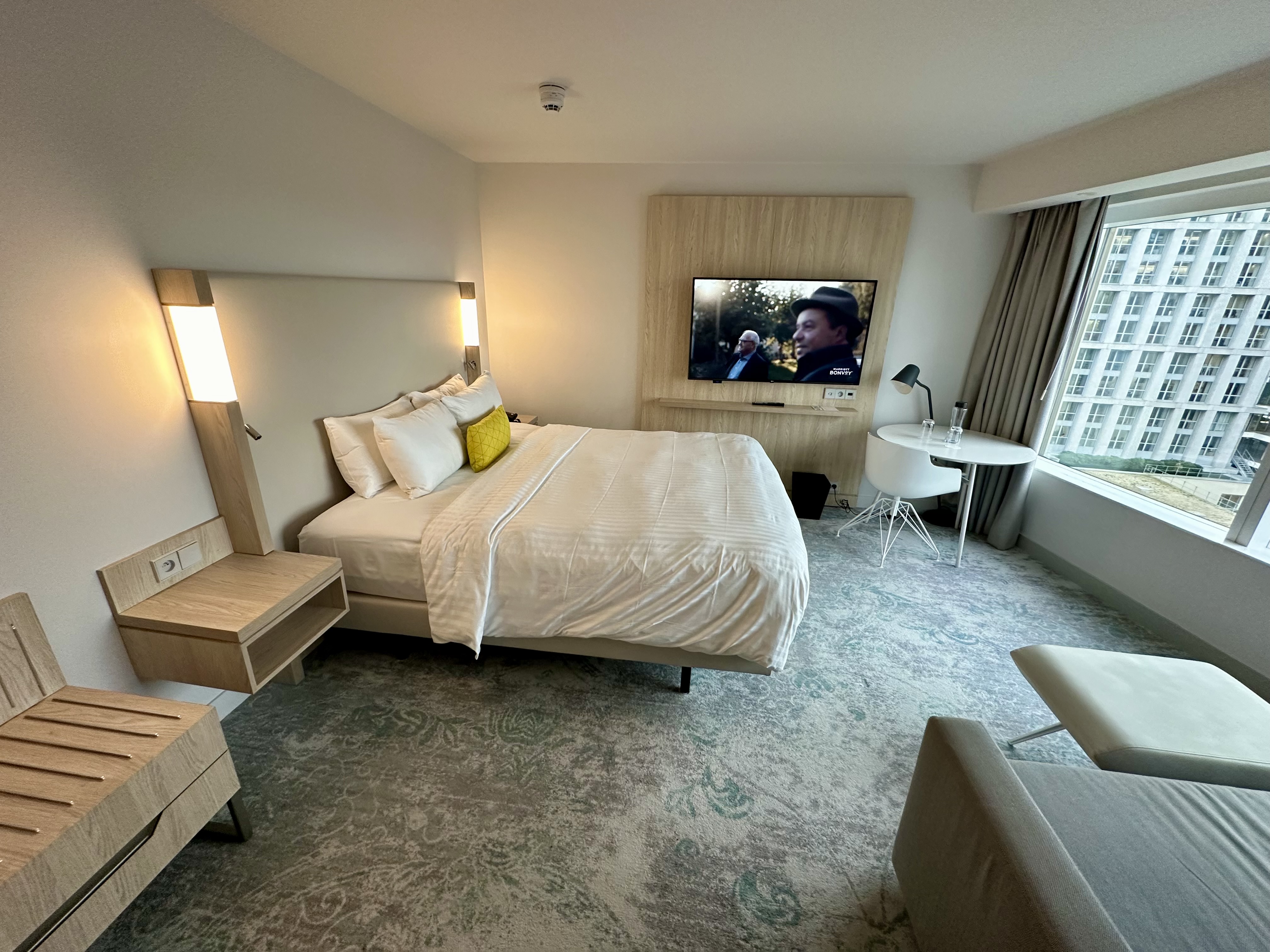 a room with a bed and a television at the Courtyard Paris Gare de Lyon