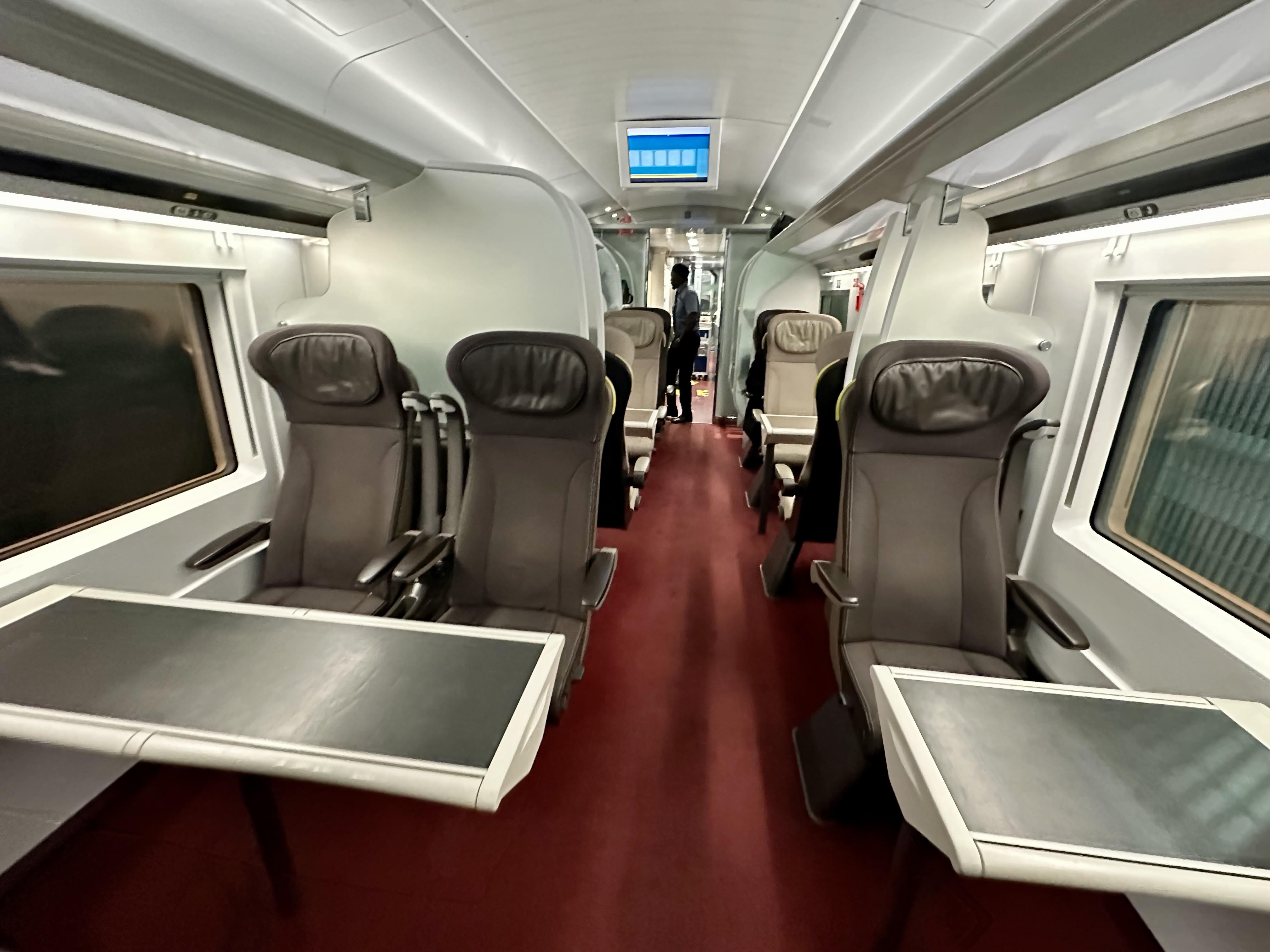 a train with seats and people in the back on Eurostar