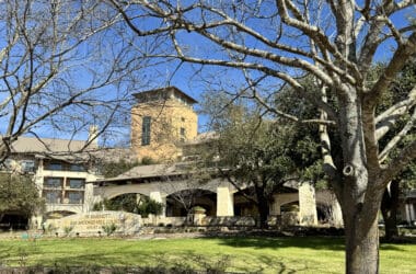 a building with trees and grass