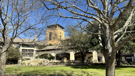 a building with trees and grass