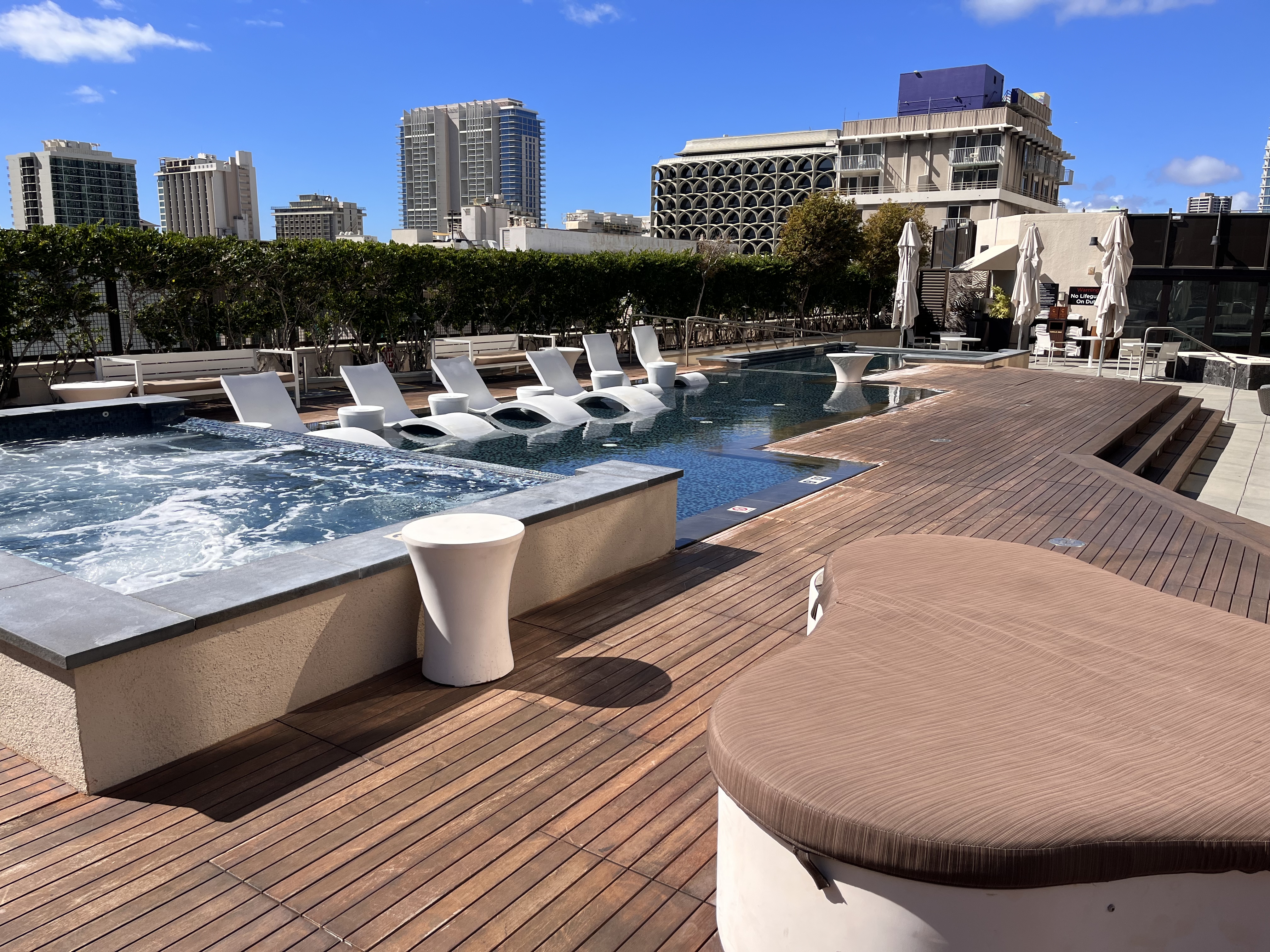 a pool with chairs and a deck