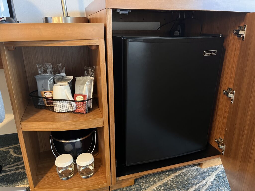a small refrigerator and a shelf