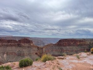a large canyon with a cloudy sky