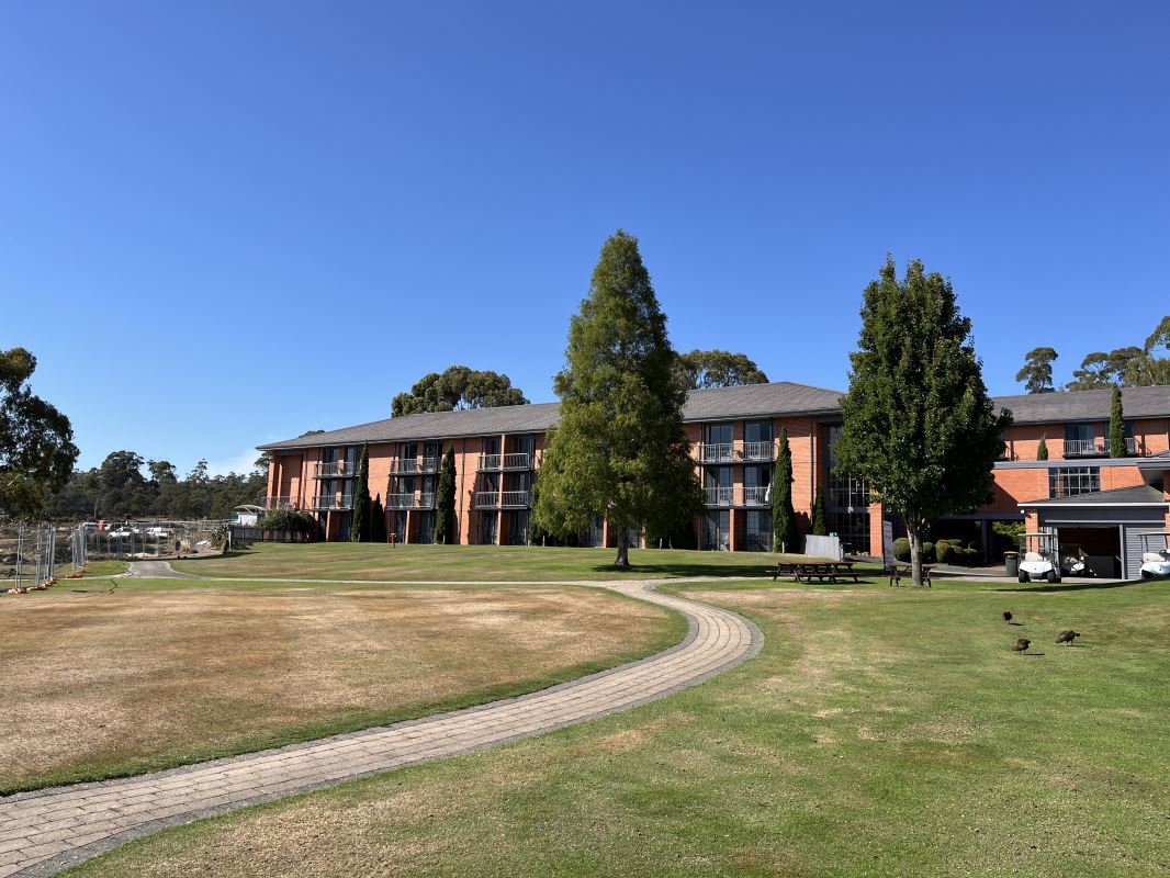 a building with trees and grass