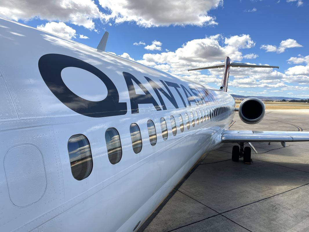 a white airplane with black text on it