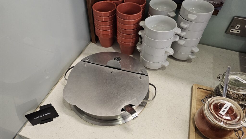 a group of white cups and a round metal object