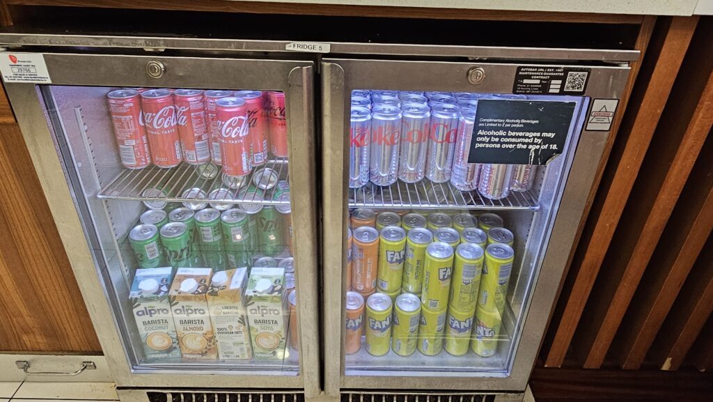 a refrigerator with cans of soda and cans of different colors