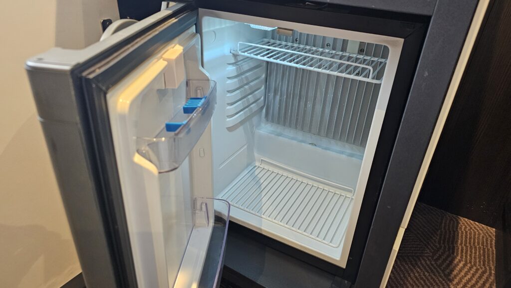 a small refrigerator with a door open