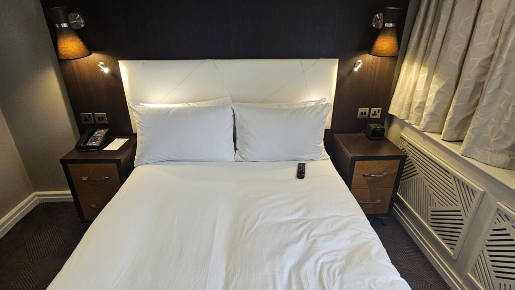 a bed with a white bedding and a white headboard