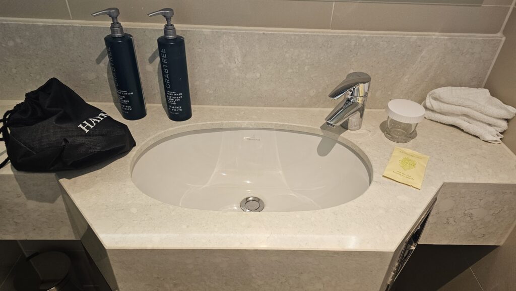 a sink with a faucet and soap bottles