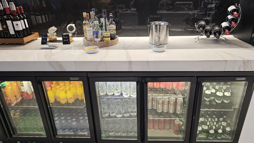 a refrigerator with drinks and bottles on it