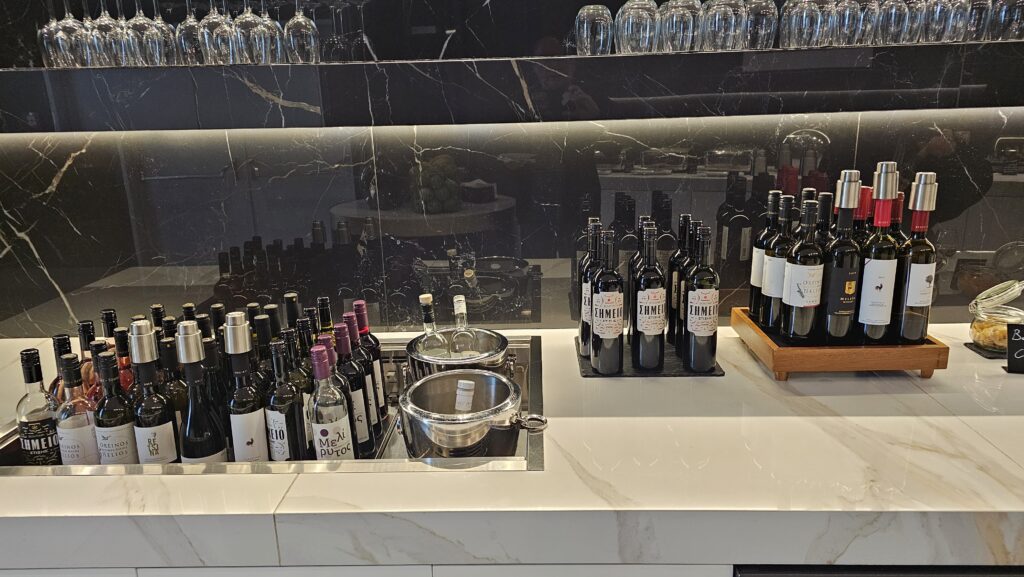 a counter with wine bottles and glasses