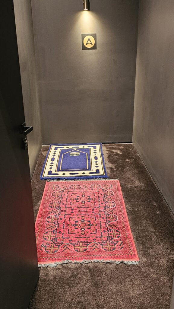 a room with a door open and two rugs