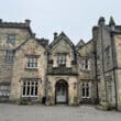 a stone building with a stone wall and a stone door