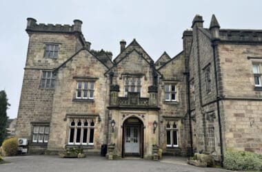 a stone building with a stone wall and a stone door