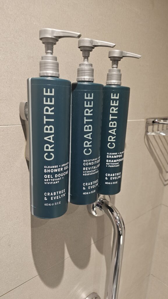 a group of shampoo bottles on a shower rod