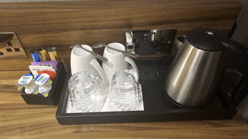 a tray with cups and mugs on it