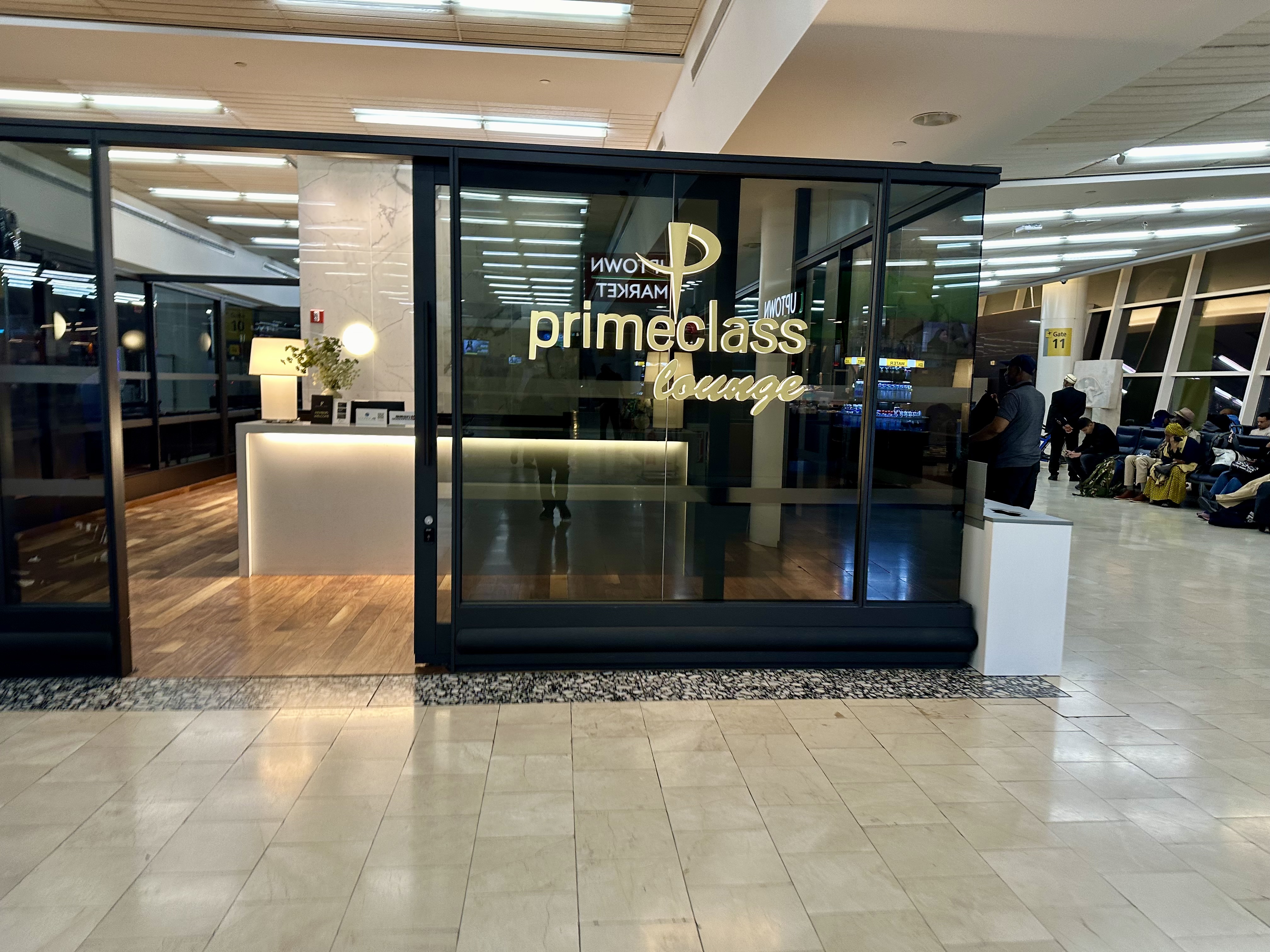 a glass door with a sign to the Primeclass Lounge New York (JFK) Terminal 1