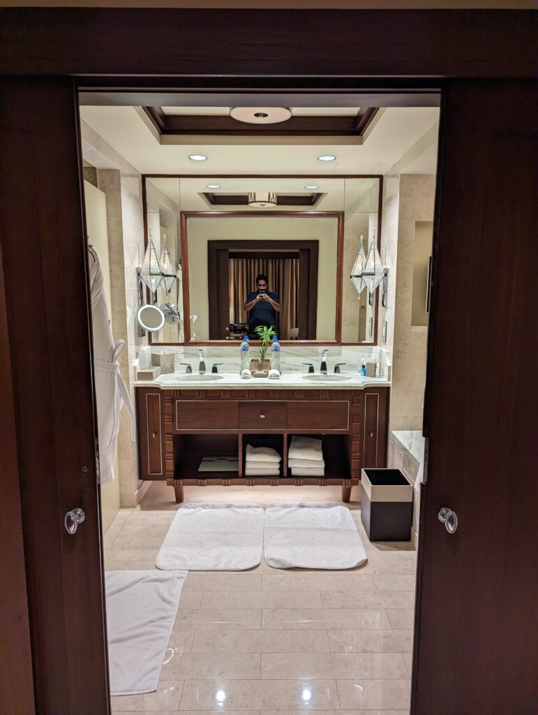 a man taking a picture of a bathroom