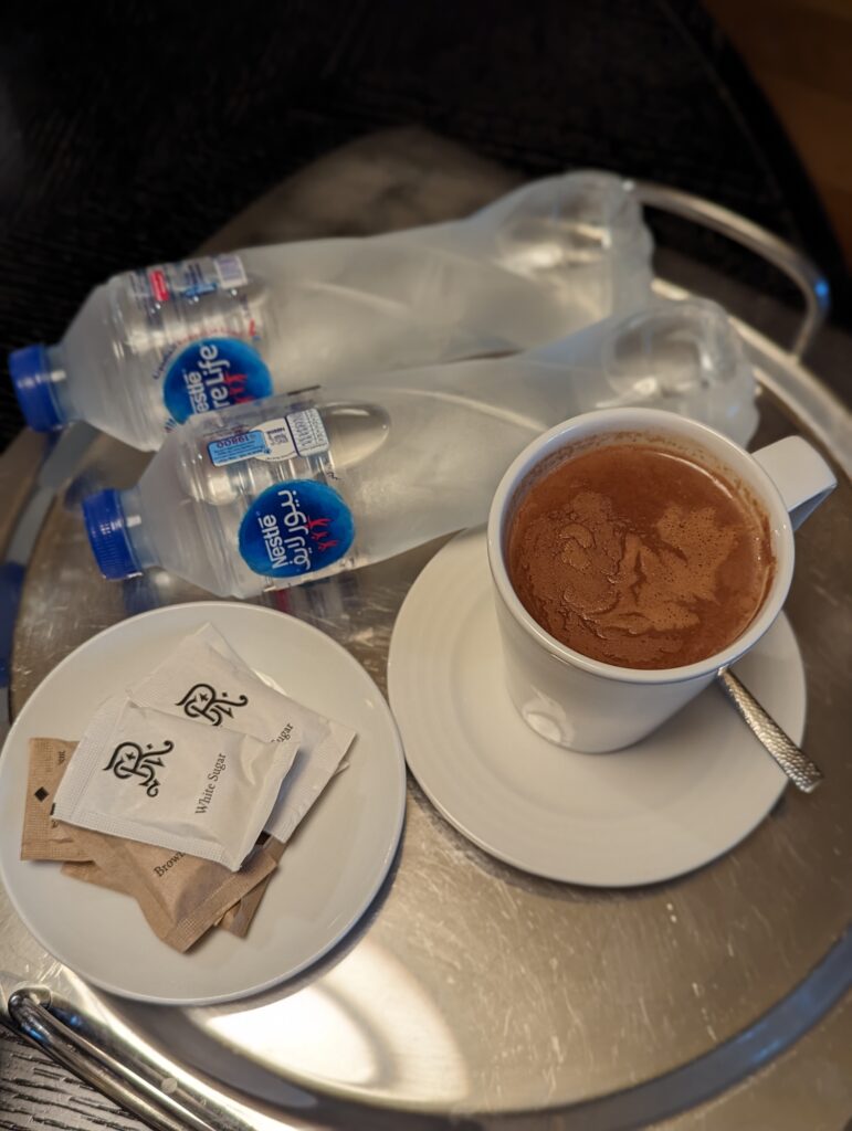 a cup of hot chocolate and some water bottles