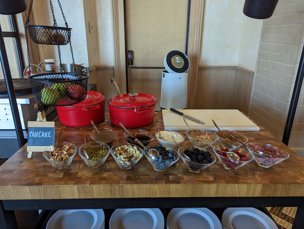 a table with bowls of food and utensils