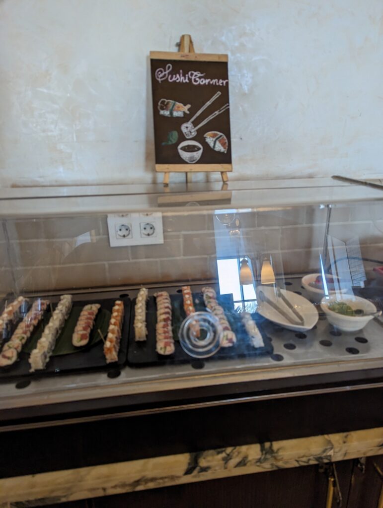 a display case with sushi rolls on it