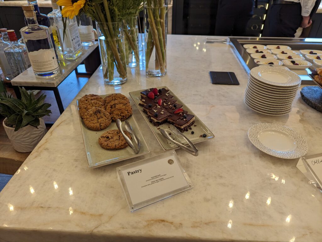 a plate of cookies and tongs on a table