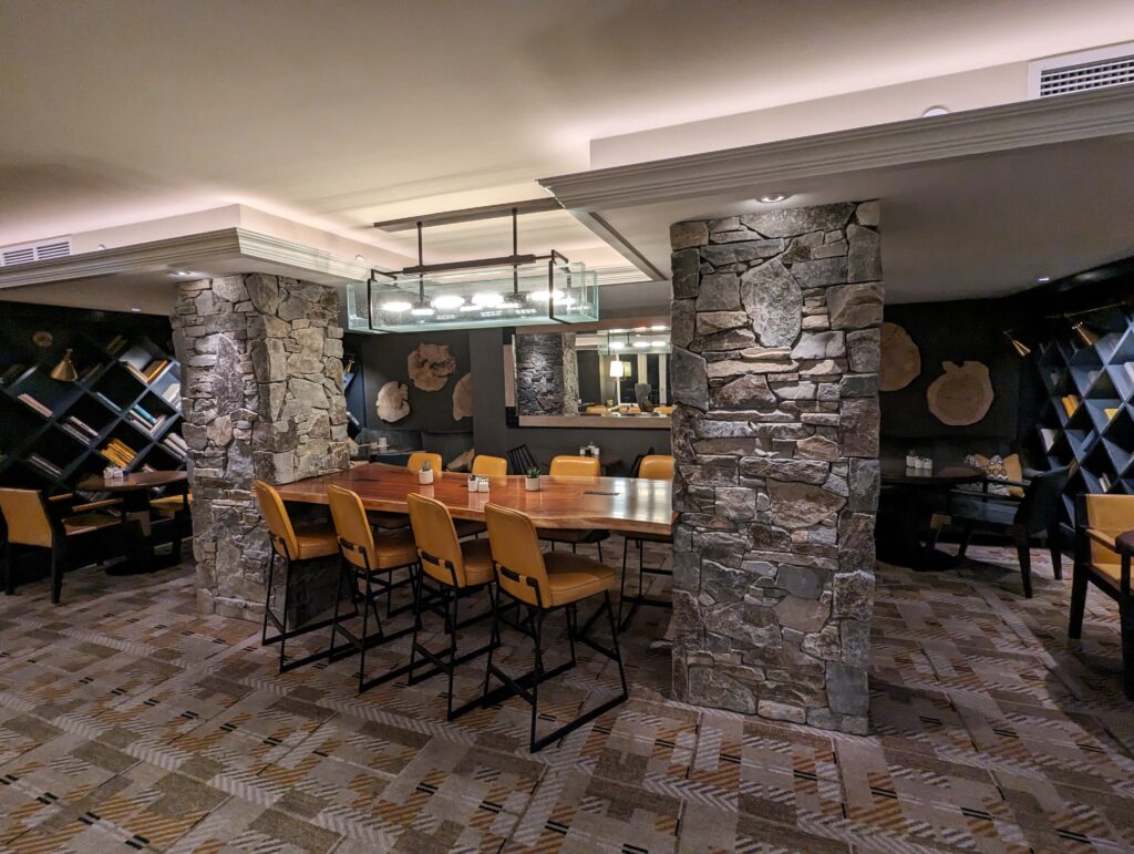 a room with stone pillars and a table