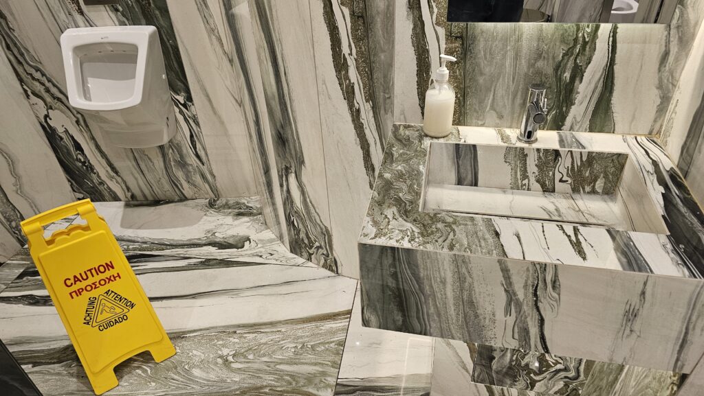 a bathroom with a sink and soap dispenser