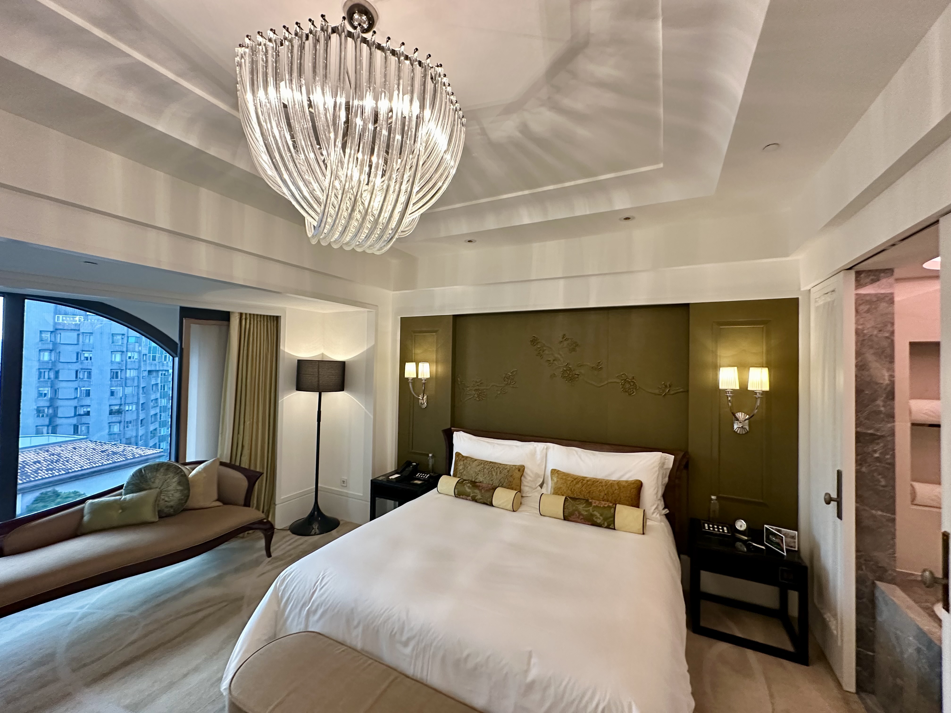 a bedroom with a bed and a chandelier at the Mandarin Oriental Taipei