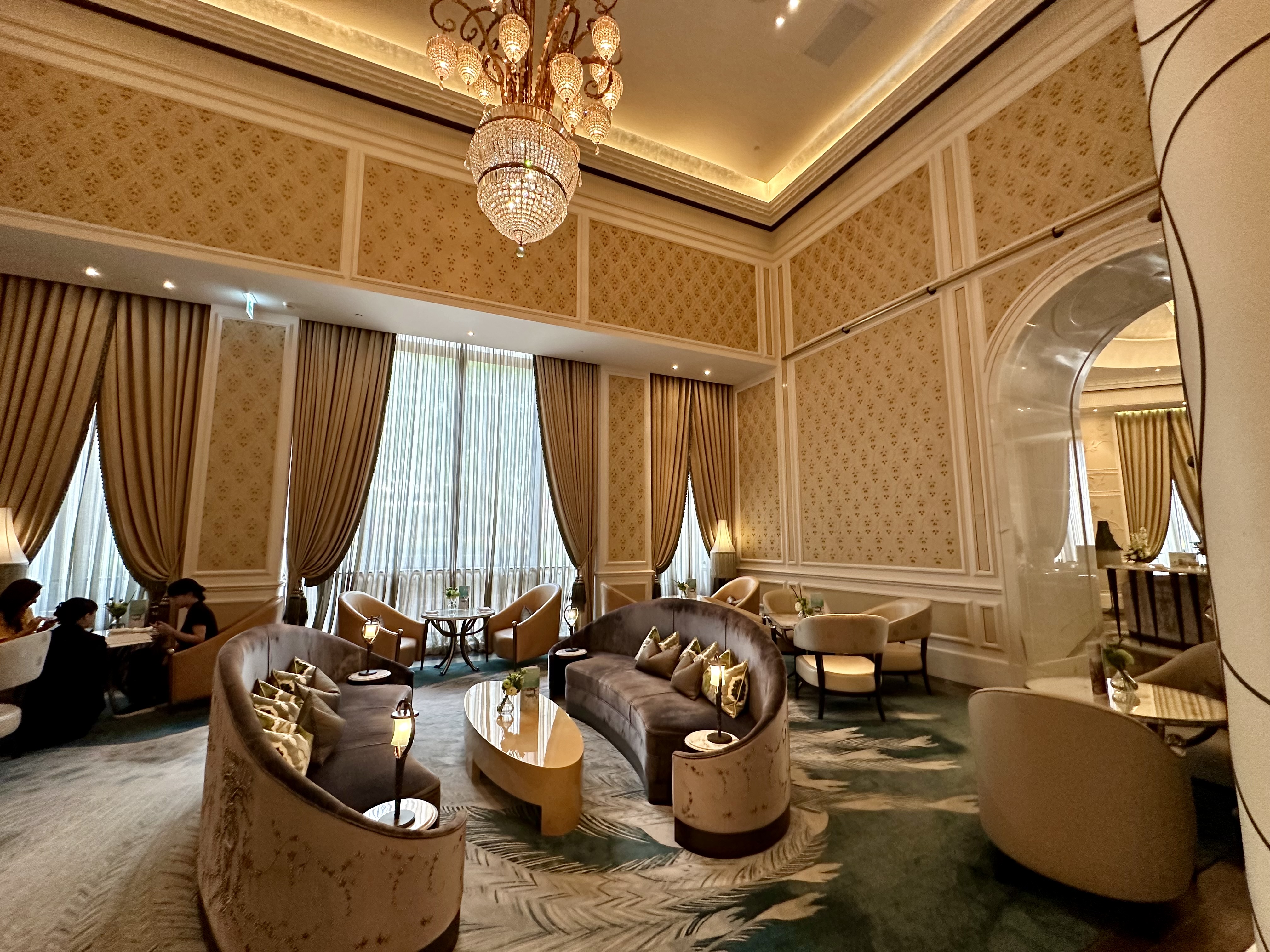 a room with a chandelier and couches at the Mandarin Oriental Taipei